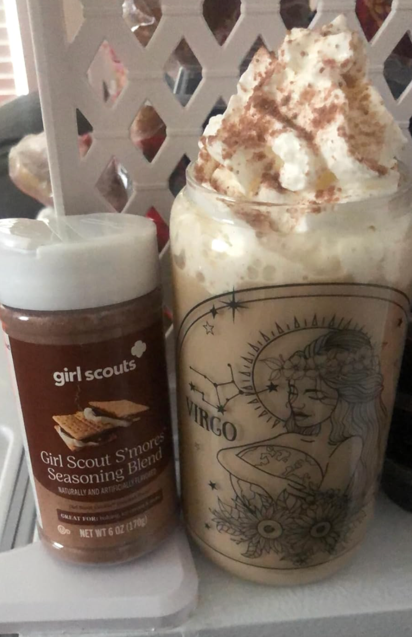 A bottle of s'mores seasoning blend next to an iced whipped coffee