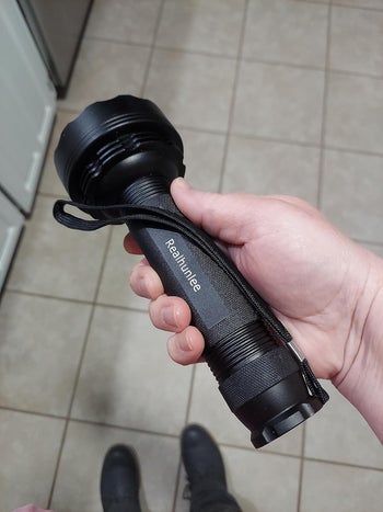 reviewer holding the flashlight