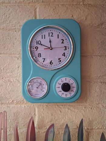 Retro-style partition  timepiece  with integrated thermometer and timer connected  a ceramic  wall