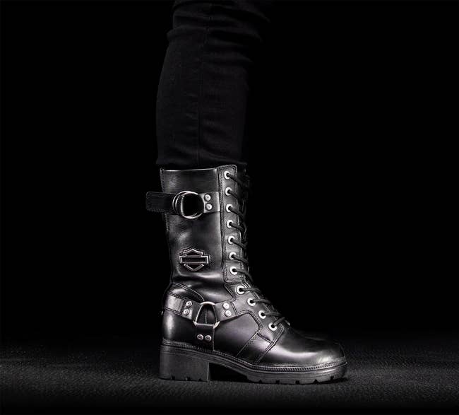 Close-up of a stylish combat footwear  with decorative buckles and laces. The footwear  has a rugged, edgy design, suitable for a modern   manner  look