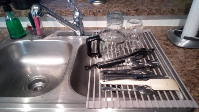reviewer's double sink with one half with rack rolled out on top