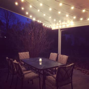 the lights above an outdoor dining table