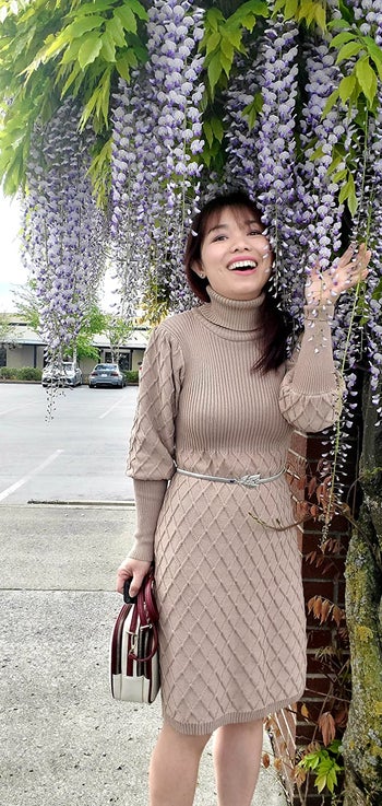 reviewer photo wearing the dress in beige, under a weeping willow tree