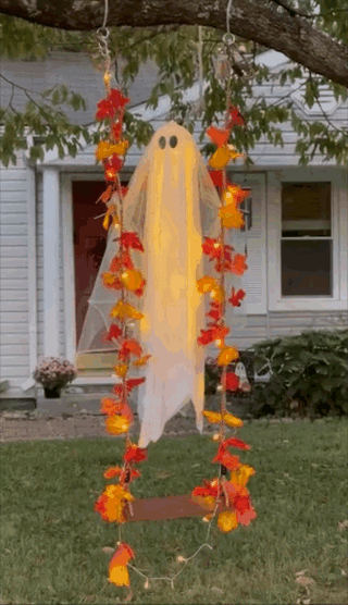 Ghost decoration connected a plaything adorned with orangish and yellowish leaves, acceptable successful beforehand of a house