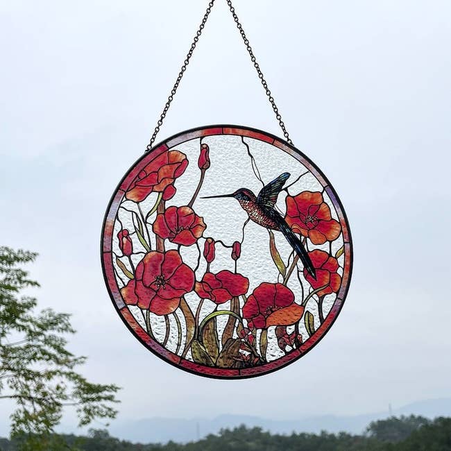 the glass suncatcher hanging in a window 
