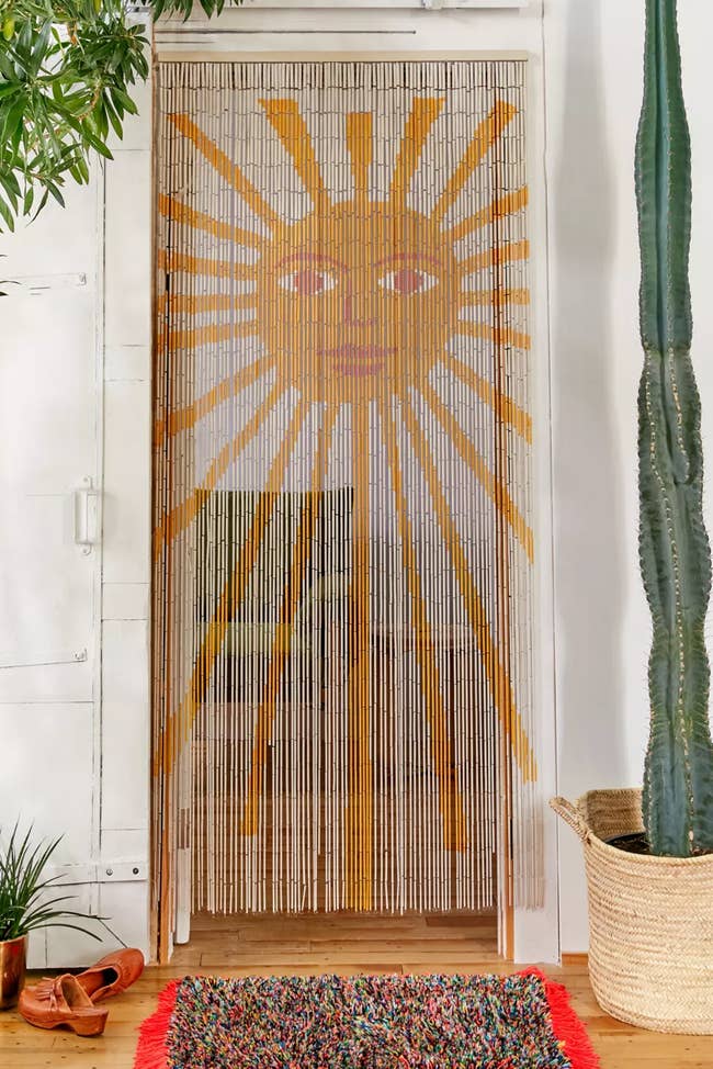 sunshine with face on beaded curtain in doorway of living room