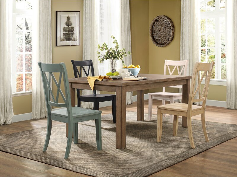 Four chairs in a variety of colors surround a table