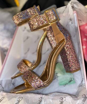 reviewer photo of the glittery pumps with buckle strap in their shoebox