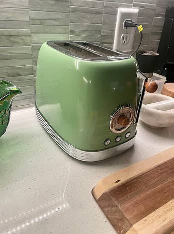 the green toaster on a reviewer's counter