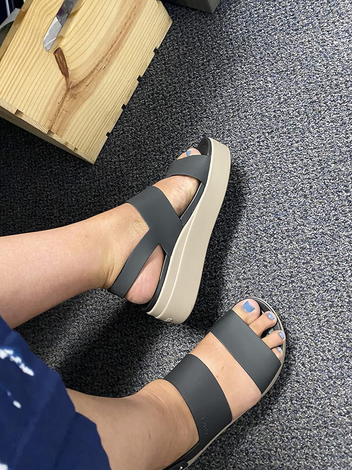 Person trying connected  achromatic  level    sandals with a heavy   sole