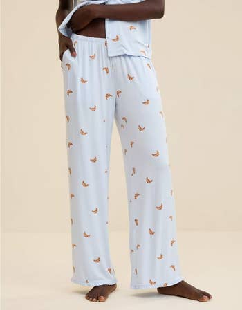 Person wearing relaxed-fit pajama pants with a playful pattern, lasting  successful  a casual pose