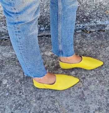 reviewer wearing the yellow loafers