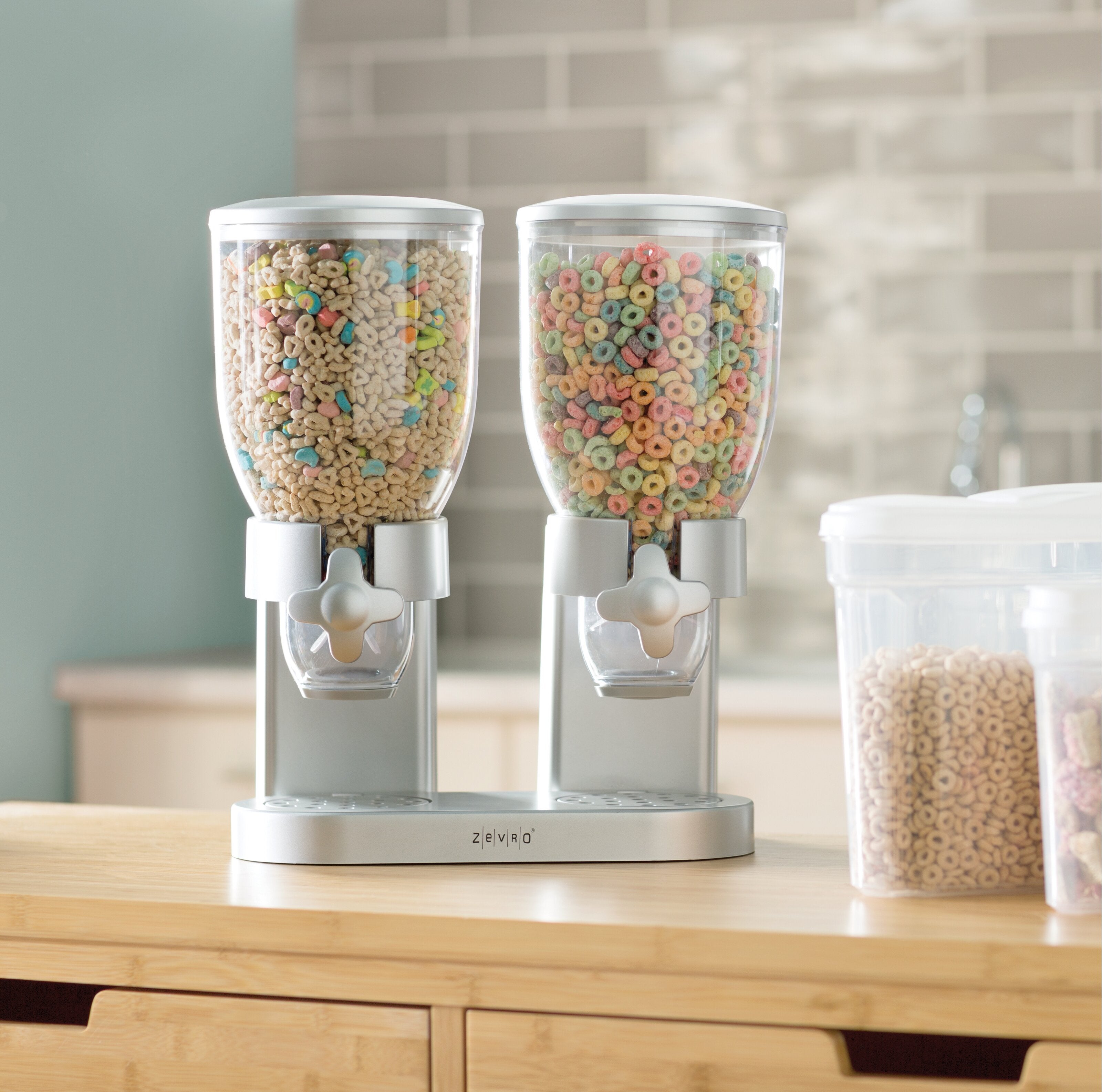 The dispenser in chrome with two large clear containers, each with a dispensing wheel
