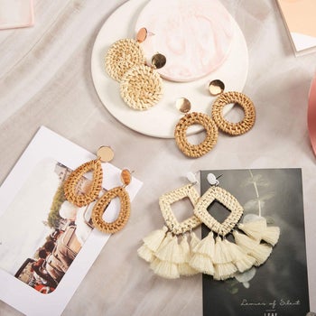 four large pairs of woven straw earrings in different shapes