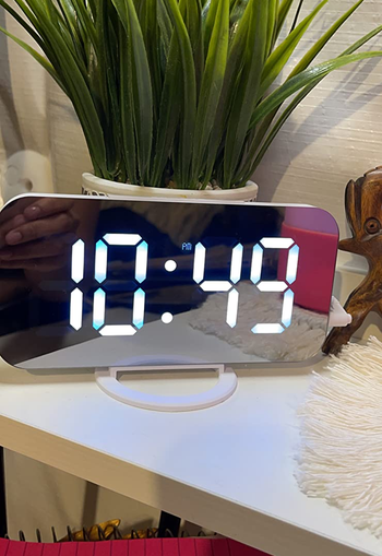 the mirrored clock on a reviewer's desk