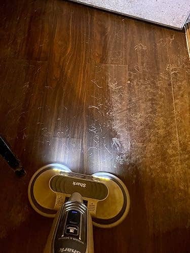A close-up of a floor-cleaning instrumentality polishing a woody floor, highlighting its ratio for sparkling cleanable results