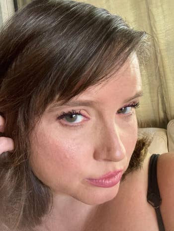 Person taking a close-up selfie with neutral expression