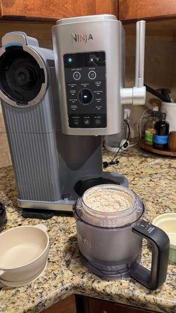 Ninja crystal  pick  shaper  connected  a room  counter, with a pitcher containing freshly made crystal  cream, 2  bare  bowls nearby