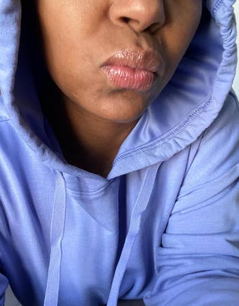 Person wearing a hoodie with a somewhat  puckered expression