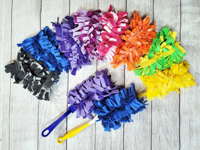 An assortment of the reusable dusters in black, blue, purple, pink, orange, green and yellow
