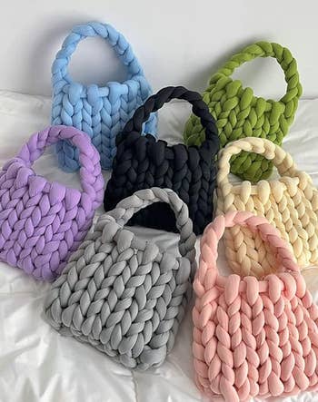 purple, grey, pink, yellow, black, blue, and green totebags lying around