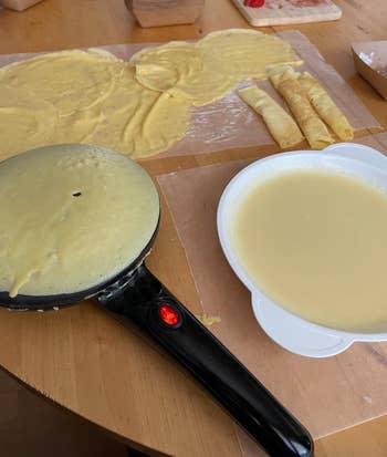 reviewers crepe pan making a crepe with batter next to it