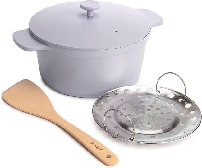 A lilac Goodful cooking set with a saucepan, lid, roasting rack, and wooden spatula