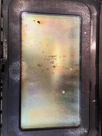 a reviewer photo of a dirty oven door