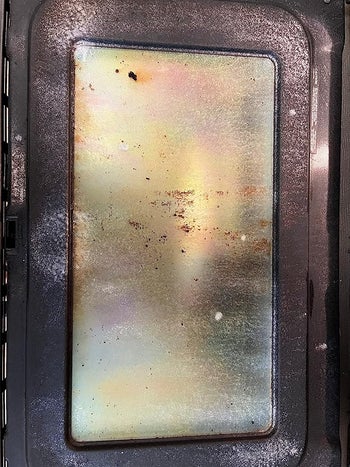 a reviewer photo of a dirty oven door