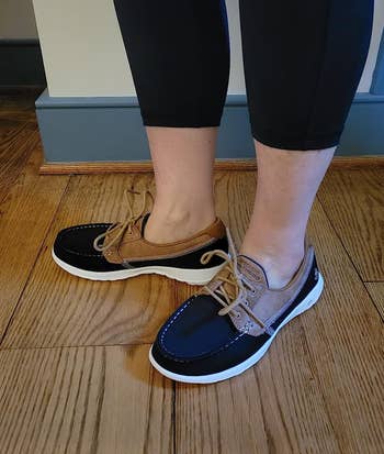 reviewer wearing the navy skechers boat shoes