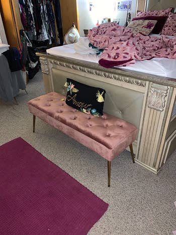 reviewer photo of the bench in pink velvet at foot of bed
