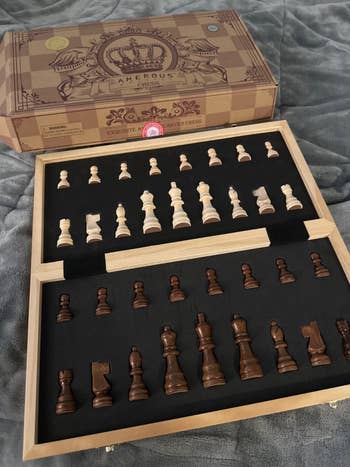 inside of chess committee  showing crippled  pieces wrong  their molds adjacent  to box