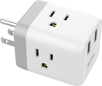 Outlet adaptor with three plugs and two USB ports