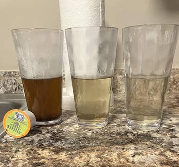Three glasses filled with dirty water becoming clearer