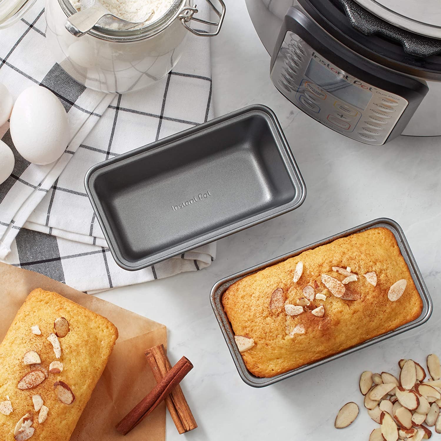 One empty pan and one pan with a cake loaf in it