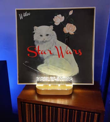 A vinyl cover of a Star Wars album propped on the same stand 