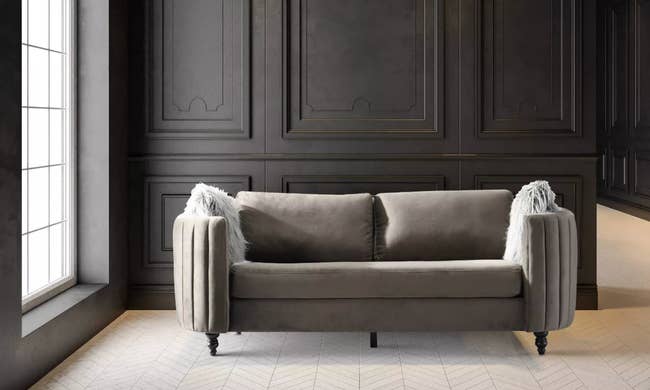 Plush velvet sofa with rounded frame in panels 