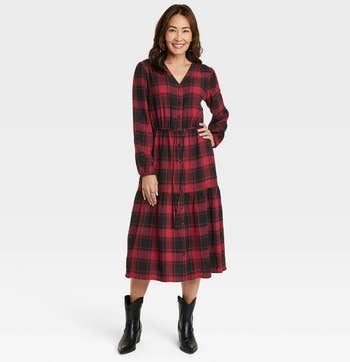 a model wearing the same plaid dress in red 