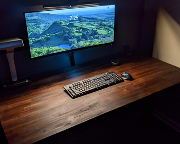 a desk lit up with the benq screenbar halo