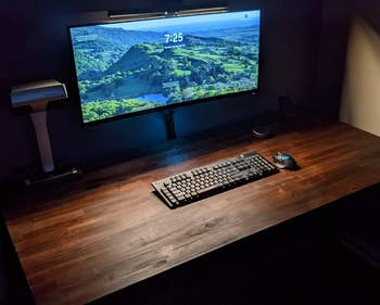 a desk lit up with the benq screenbar halo