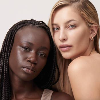 two models with different skin tones wearing the skin tint