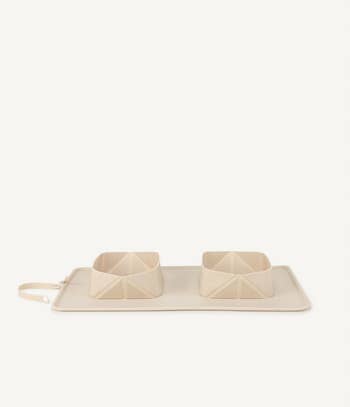the two bowls on a mat in tan