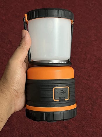 reviewer photo holding camping lantern