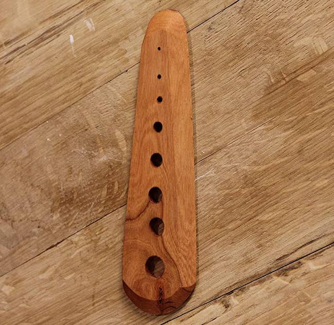 the wooden herb stripper, which has eight holes of different sizes