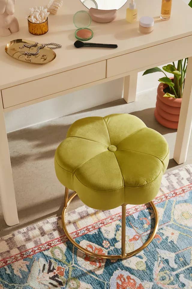 a flower-shaped vanity stool in light green