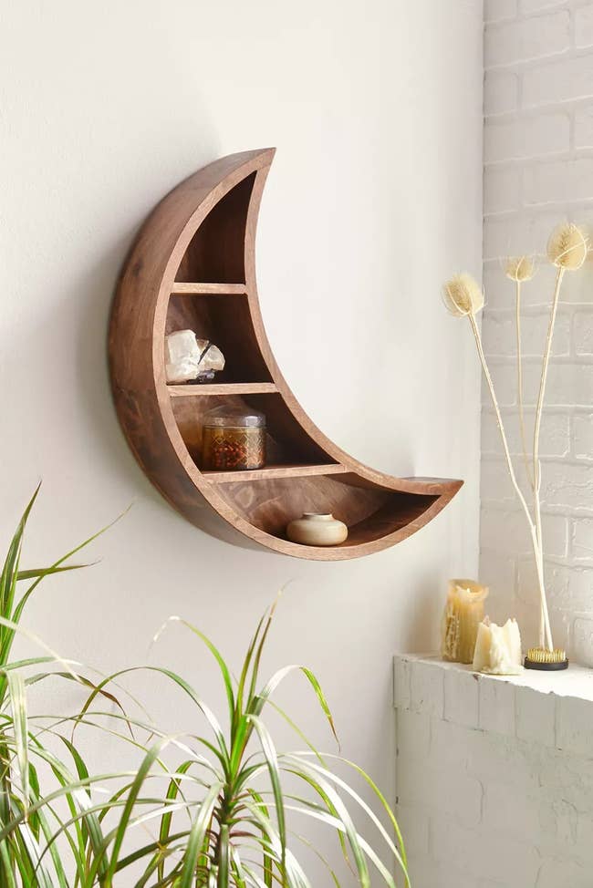 the crescent moon wall shelf mounted to a wall