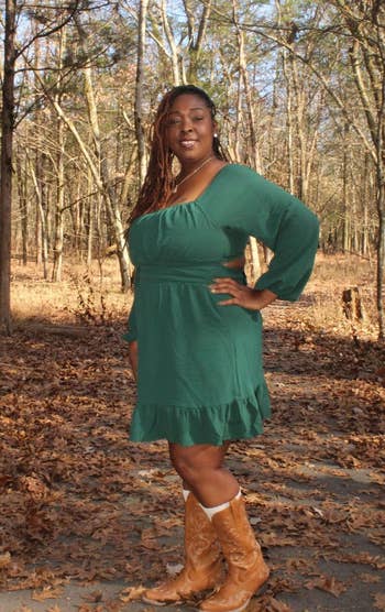 Person successful a woodland setting, wearing a ruffled greenish formal and brownish cowboy boots, poses confidently with 1 manus connected hip