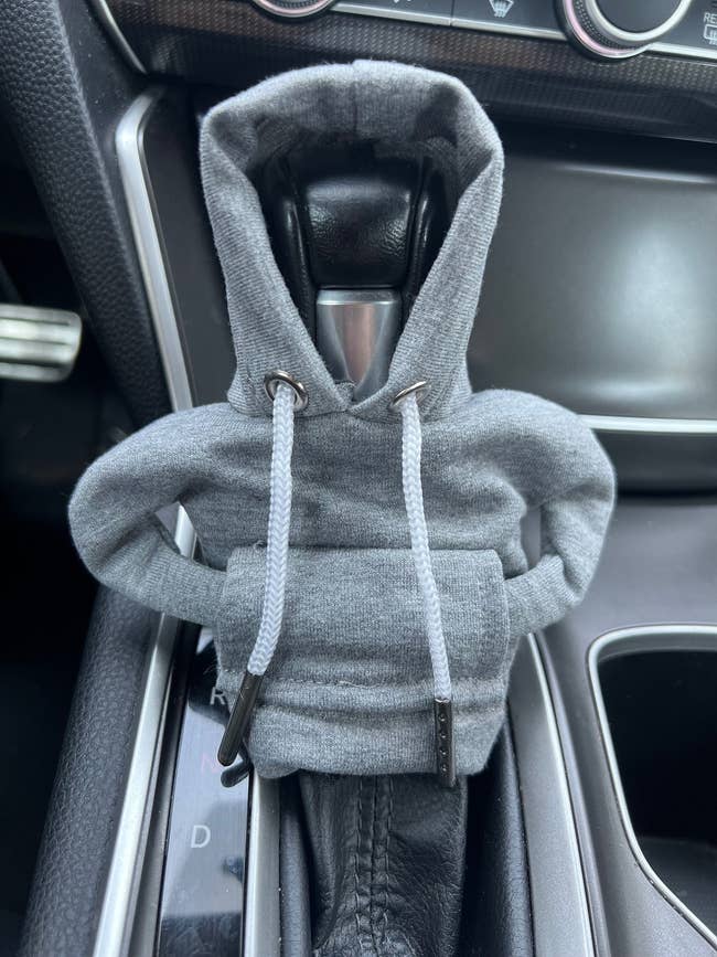 gray hoodie on a car gear shift
