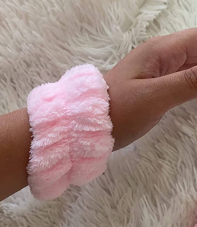 Reviewer wearing the towel cuff in light pink