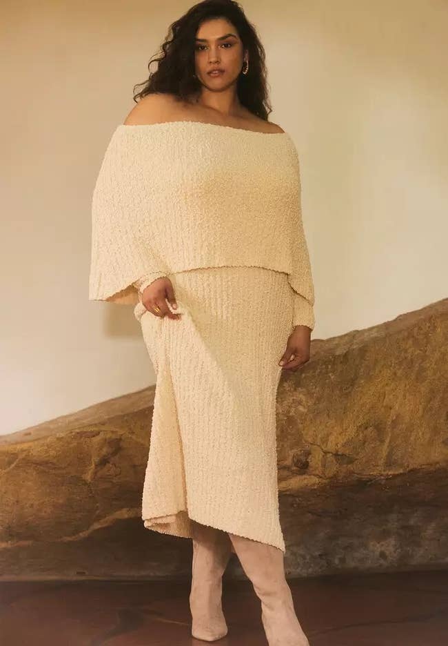 model in the cream off-shoulder maxi sweater dress